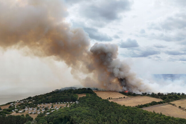 smoke-rises-from-a-wildfire-at-dunwich-heath-near-leiston-where-a-major-incident-has-been-declared-as-firefighters-battle-a-large-heathland-blaze-on-the-suffolk-coast-picture-date-thursday-july-30
