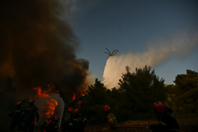 a-firefighting-helicopter-drops-water-over-a-smoke-filled-forest-during-a-wildfire-near-porto-germeno-northwest-of-athens-greece-sunday-aug-2-2026-ap-photomichael-varaklas