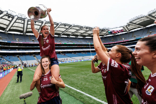 kate-geraghty-celebrates-with-the-brendan-martin-cup-on-top-of-aoife-ni-ruairc-after-winning