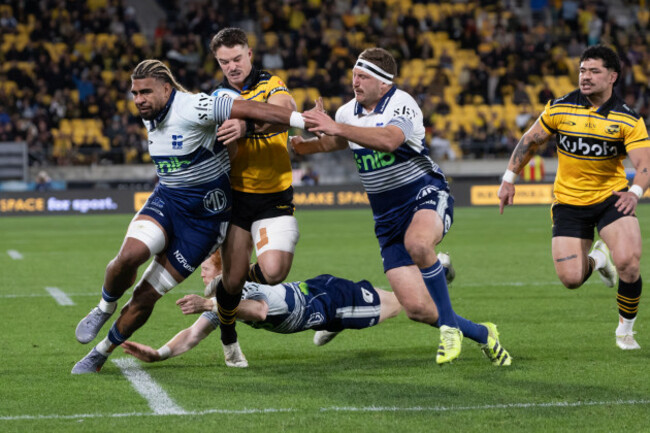 wellington-new-zealand-13th-june-2026-hurricanes-fullback-callum-harkins-with-ball-in-hand-gets-squeezed-by-bllues-hoskins-sotutu-and-bradley-slater-wellington-hurricanes-v-auckland-blue-super