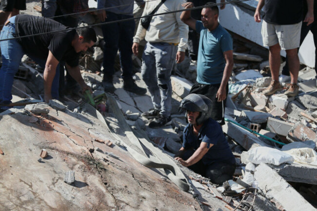 residents-and-rescue-workers-search-through-the-rubble-of-a-collapsed-building-after-an-earthquake-struck-cali-colombia-monday-aug-10-2026-ap-photosantiago-saldarriaga
