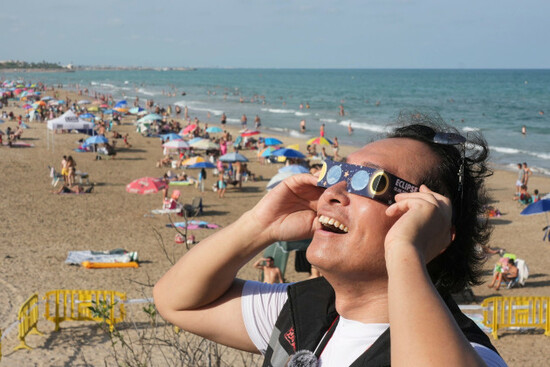 a-man-wears-special-eclipse-glasses-as-beachgoers-gather-before-a-total-solar-eclipse-set-to-begin-around-sunset-at-a-beach-near-valencia-spain-wednesday-aug-12-2026-ap-photoalberto-saiz