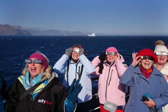 passengers-on-board-the-ambassador-cruise-ship-ambition-watching-the-start-of-the-total-solar-eclipse-off-the-coast-of-greenland-picture-date-wednesday-august-12-2026
