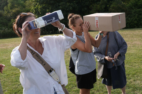people-watching-the-start-of-solar-eclipse-using-homemade-viewers-made-from-cereal-boxes-in-tynemouth-tyne-and-wear-on-the-north-east-coast-of-england-the-first-total-solar-eclipse-visible-over-mai