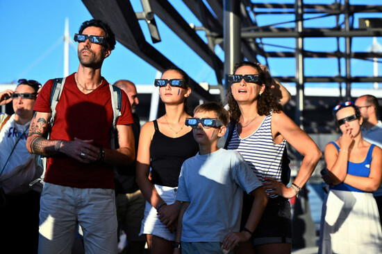 paris-france-12th-aug-2026-paris-france-20260812people-watch-the-solar-eclipse-outside-the-olympic-aquatic-centre-during-the-european-swimming-championships-in-paris-the-image-is-included-in