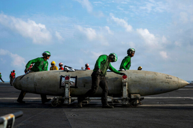 undisclosed-location-united-states-21-march-2026-u-s-navy-sailors-move-a-fa-18-fighter-aircraft-fuel-tank-on-the-flight-deck-of-the-nimitz-class-aircraft-carrier-uss-abraham-lincoln-during-opera