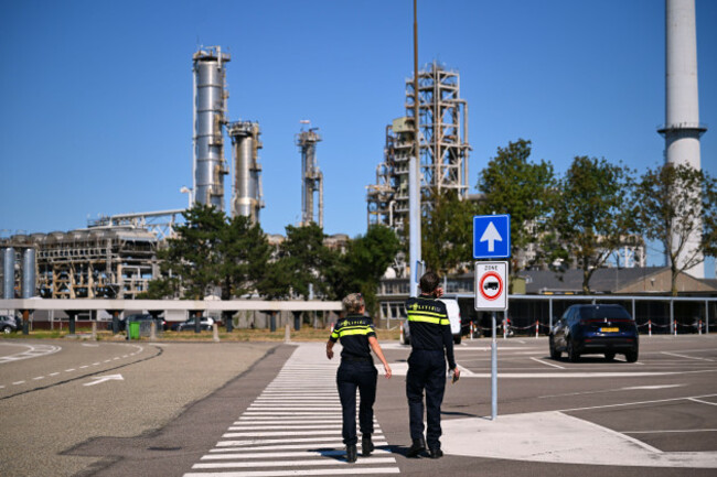 police-officers-walk-to-a-refinery-and-fuel-terminal-run-by-gunvor-energy-after-an-explosion-at-the-dutch-port-of-rotterdam-which-killed-at-least-one-person-and-injured-several-others-according-to-pol