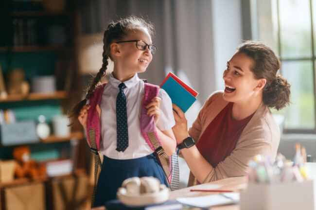 joyful-morning-moment-as-a-smiling-mother-supports-her-daughter-in-school-uniform-ready-for-her-first-day-back-to-school-the-nurturing-encouragemen
