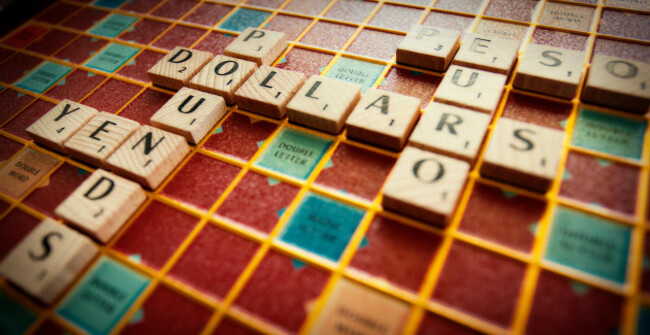 various-world-currencies-spelled-out-on-a-scrabble-board