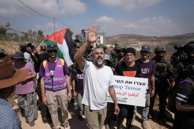 activists-march-with-food-and-water-supplies-toward-the-houses-of-three-palestinian-families-that-have-been-besieged-by-israeli-settlers-for-six-days-in-the-occupied-west-bank-village-of-qusra-south