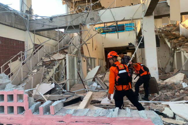 in-this-photo-released-by-the-indonesian-national-search-and-rescue-agency-basarnas-rescuers-search-for-victims-at-a-damaged-building-following-an-earthquake-in-maumere-east-nusa-tenggara-province