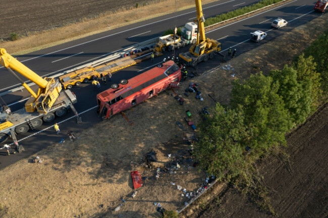 an-aerial-photo-taken-by-drone-shows-the-emergency-services-as-they-attend-the-scene-after-a-passenger-bus-went-off-the-road-and-overturned-in-a-ditch-along-a-highway-between-mezokeresztes-and-mezonag
