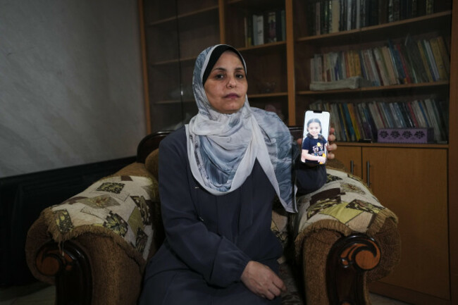 hind-rajab-poses-in-gaza-city-wednesday-aug-19-2026-with-a-photo-of-her-granddaughter-hind-rajab-a-5-year-old-palestinian-girl-who-was-killed-alongside-her-family-in-gaza-in-february-2024-ap