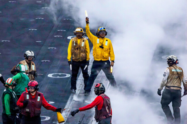 undisclosed-location-united-states-14-august-2026-a-u-s-navy-sailors-signal-a-fa-18f-super-hornet-fighter-aircraft-to-prepare-for-launch-on-the-flight-deck-of-the-nimitz-class-aircraft-carrier-u