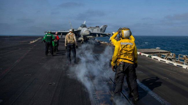 undisclosed-location-united-states-10-august-2026-u-s-navy-sailors-signal-a-fa-18f-super-hornet-fighter-aircraft-with-the-black-aces-of-strike-fighter-squadron-41-to-prepare-for-launch-on-the-f