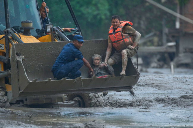 rescuers-use-an-earthmover-to-carry-a-victim-of-flash-flooding-to-safety-along-the-trishuli-river-in-nepals-nuwakot-district-wednesday-aug-26-2026-ap-photoniranjan-shrestha