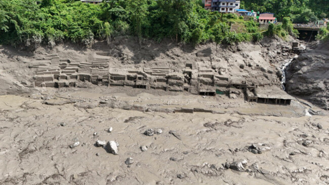 nuwakot-nepal-26th-aug-2026-an-aerial-view-shows-buildings-and-infrastructure-damaged-along-the-swollen-trishuli-river-following-a-massive-flash-flood-triggered-by-an-avalanche-of-ice-and-rock-in