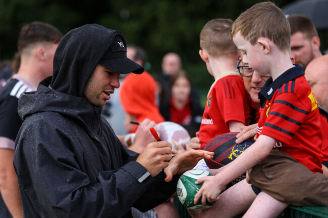 jack-crowley-signs-an-autograph-for-a-young-fan-after-the-game