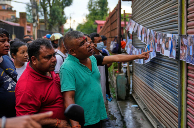 people-look-at-photographs-of-people-killed-in-flash-floods-displayed-outside-a-government-hospital-to-help-relatives-identify-the-victims-in-kathmandu-nepal-friday-aug-28-2026-ap-photodar-yas