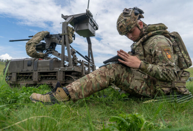a-ukrainian-serviceman-of-the-cerberus-ground-unmanned-systems-company-of-the-60th-separate-mechanized-brigade-third-army-corps-prepares-for-a-drill-with-a-combat-ground-drone-during-a-training-at-t