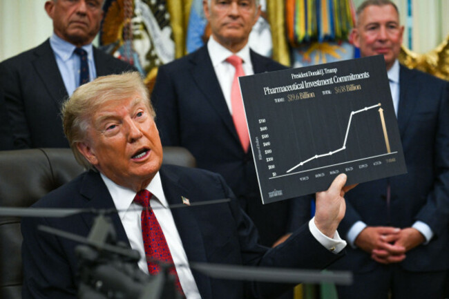 united-states-president-donald-j-trump-holds-up-a-sign-as-he-hosts-an-announcement-on-healthcare-affordability-in-the-oval-office-of-the-white-house-in-washington-dc-usa-on-monday-august-31-2026