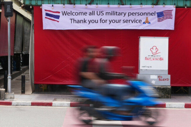 a-motorcycle-taxi-drives-past-a-banner-in-pattaya-thailand-tuesday-sept-1-2026-ap-photosakchai-lalit