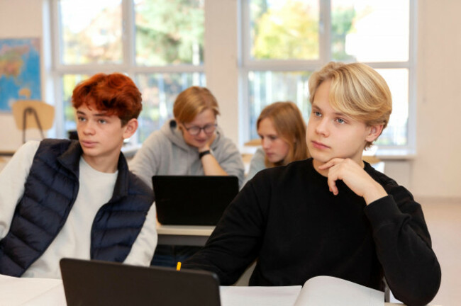 teenage-boys-using-laptops-in-classroom