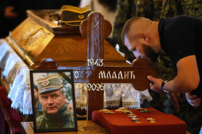 a-man-kisses-the-cross-of-the-former-bosnian-serb-army-commander-ratko-mladic-who-died-last-week-while-serving-a-life-sentence-for-genocide-and-other-atrocities-during-the-war-in-bosnia-at-the-st-l