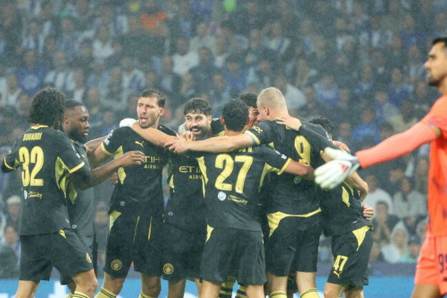 manchester-city-players-celebrate-after-erling-haaland-right-scored-the-opening-goal-during-a-champions-league-opening-phase-soccer-match-between-fc-porto-and-manchester-city-in-porto-portugal-tue