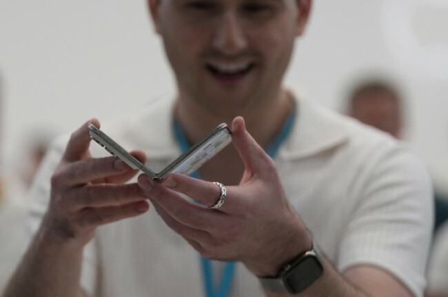 an-attendee-holds-up-an-iphone-duo-during-an-announcement-of-new-products-on-wednesday-sept-9-2026-on-the-apple-campus-in-cupertino-calif-ap-photojeff-chiu