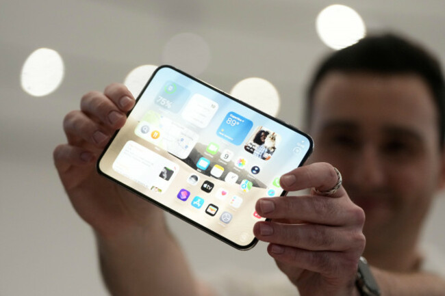 an-attendee-holds-up-an-iphone-duo-during-an-announcement-of-new-products-on-wednesday-sept-9-2026-on-the-apple-campus-in-cupertino-calif-ap-photojeff-chiu