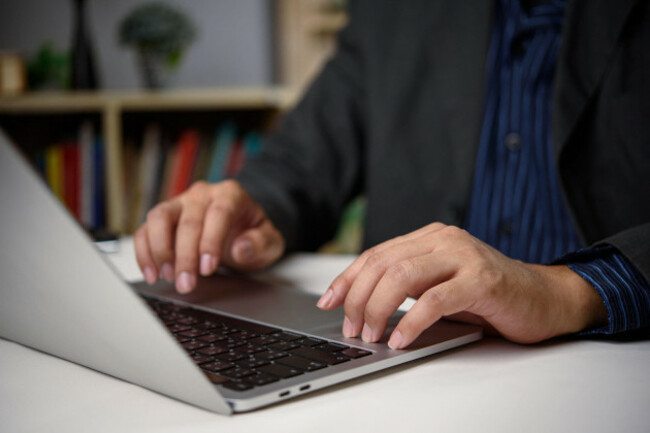 businessman-using-laptop-in-office-with-bookshelf-background-concept-of-knowledge-work-productivity-and-digital-online-working-business-in-professi