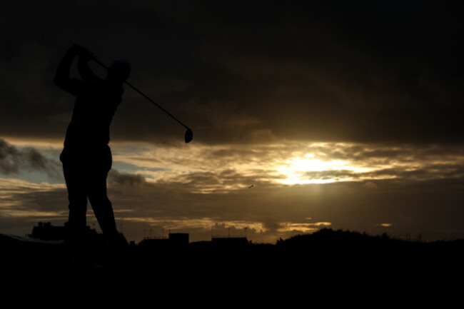 rory-mcilory-tees-off-the-eighteenth-as-the-sun-sets-over-the-course