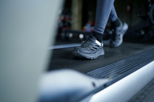 woman-exercising-on-treadmill-wearing-black-athletic-shoes-and-leggings-in-contemporary-health-club-gym-facility
