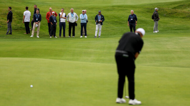 eric-trump-and-his-security-team-watch-on-as-shane-lowry-putts-for-par-on-the-second-green