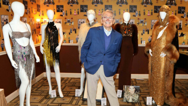 december-2-2024-new-york-new-york-usa-american-fashion-designer-and-costumier-bob-mackie-seen-with-his-creations-l-r-bob-mackie-2002-beaded-evening-dress-worn-by-miley-cyrus-for-her-performanc