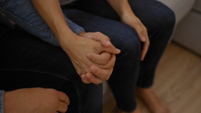 hands-of-a-man-and-woman-holding-together-in-a-close-up-shot-depicting-love-and-unity-at-home-in-a-cozy-living-room-setting