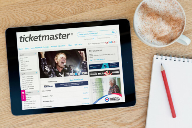 the-ticketmaster-website-on-an-ipad-tablet-device-which-rests-on-a-wooden-table-beside-a-notepad-and-pencil-and-a-cup-of-coffee-editorial-only
