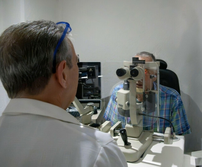 ophthalmologist-with-patient-using-diagnostic-eye-testing-equipment-in-eye-clinic