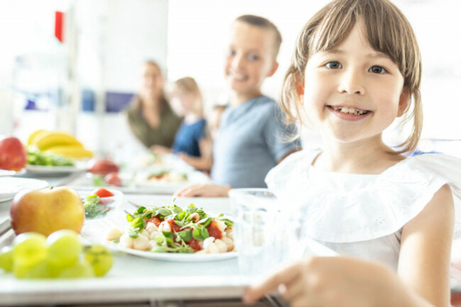smiling-student-with-healthy-lunch-at-school-cafeteria