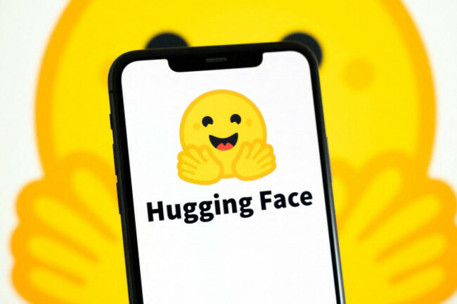 paris-france-july-23-2026-a-smartphone-showing-the-logo-of-hugging-face-held-in-front-of-a-yellow-background-displaying-the-brand-mascot