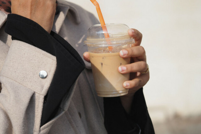 woman-holding-iced-drink-on-a-sunny-day-in-the-city