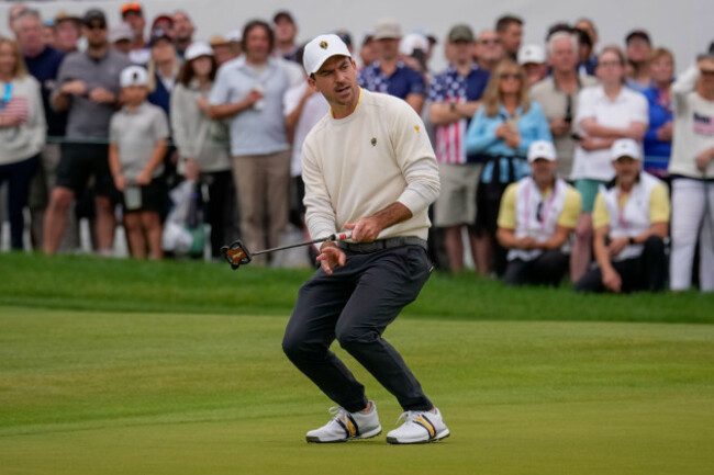 international-teams-nick-taylor-of-canada-reacts-to-missing-his-putt-on-the-seventh-green-against-the-usa-team-during-the-presidents-cup-golf-tournament-second-round-foursomes-match-at-medinah-coun
