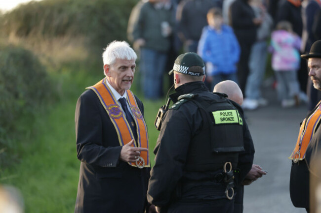 nigel-dawson-portadown-district-master-speaks-to-a-police-officer-as-the-orange-men-gather-at-drumcree-church-near-to-where-police-have-formed-a-barricade-to-prevent-them-entering-the-garvaghy-road
