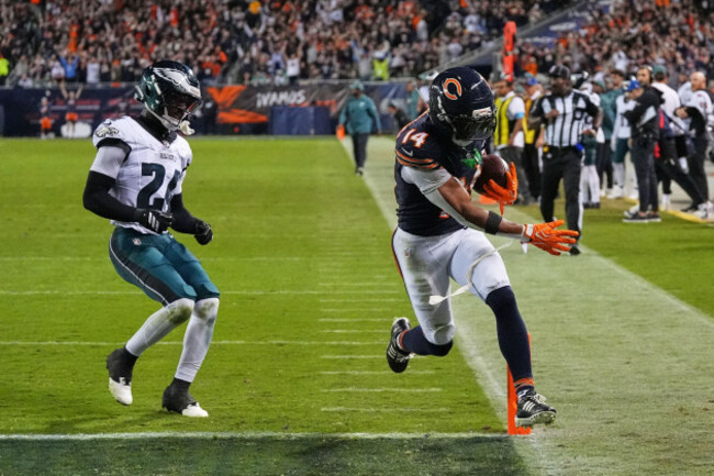 chicago-bears-wide-receiver-kalif-raymond-14-catches-a-pass-and-runs-for-a-touchdown-as-philadelphia-eagles-safety-andrew-mukuba-24-defends-during-the-second-half-of-an-nfl-football-game-in-chicag
