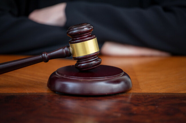 judge-gavel-on-wooden-court-desk-blur-female-crossed-hands-close-up-view-justice-and-law-concept-lawyer-office