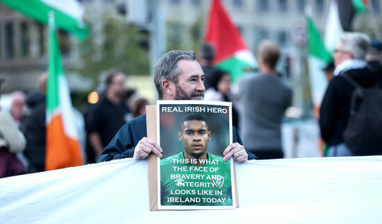 a-protestor-displays-an-image-of-gavin-bazunu