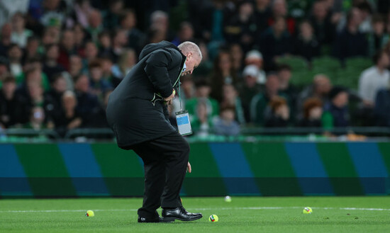staff-remove-tennis-balls-thrown-onto-the-field-by-protestors