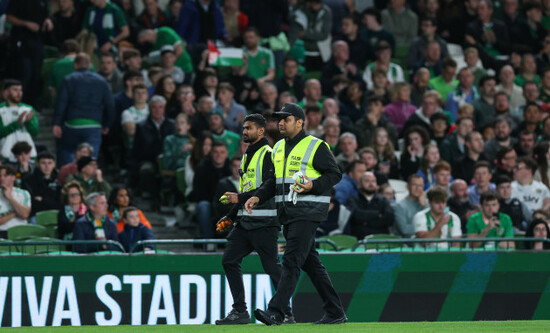 staff-remove-tennis-balls-thrown-onto-the-field-by-protestors