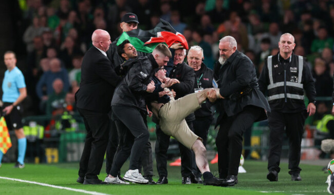 security-staff-remove-a-pitch-invader